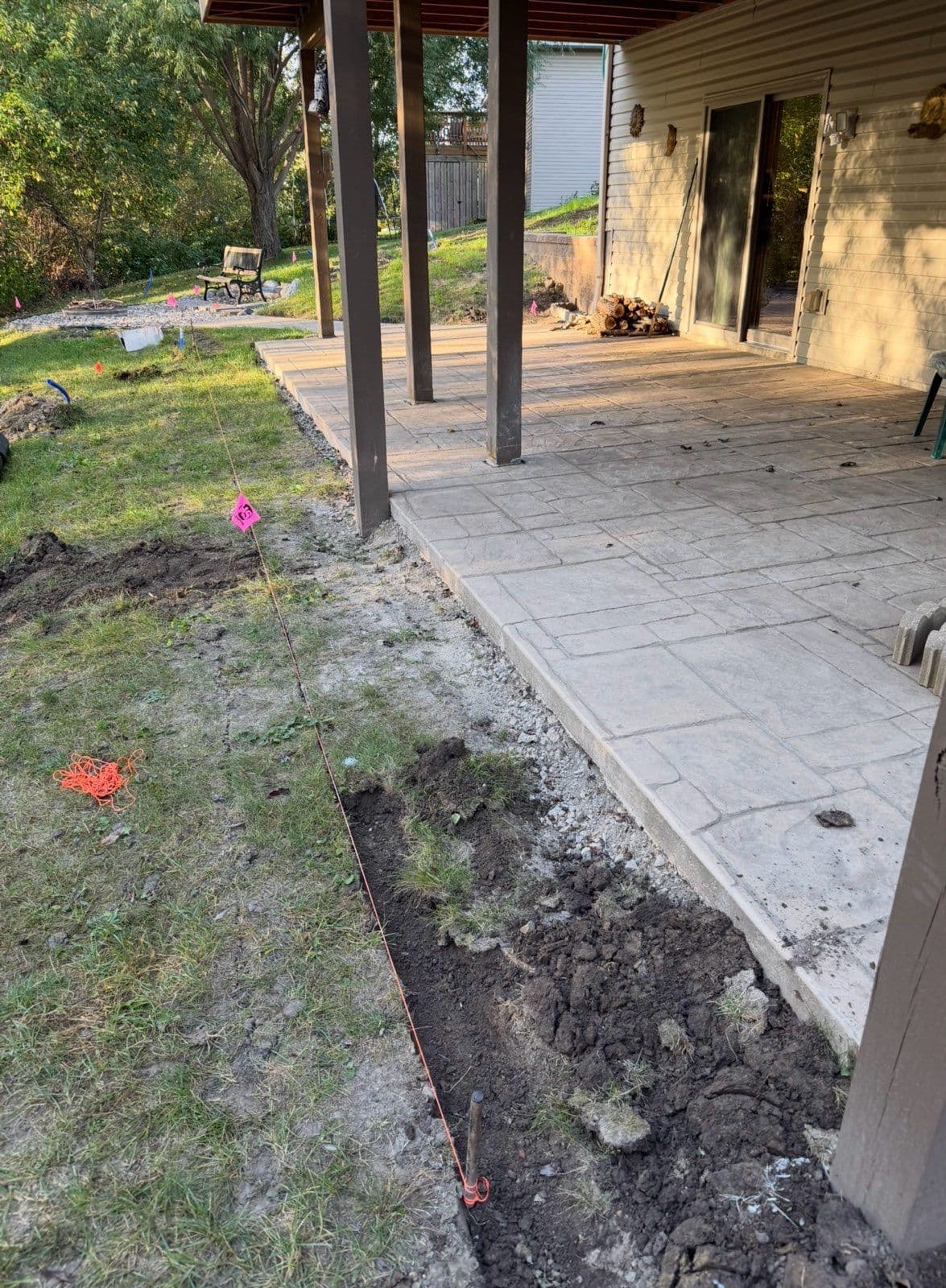 Enhancing Patio Edges with Bullet Pavers and Decorative Rock image