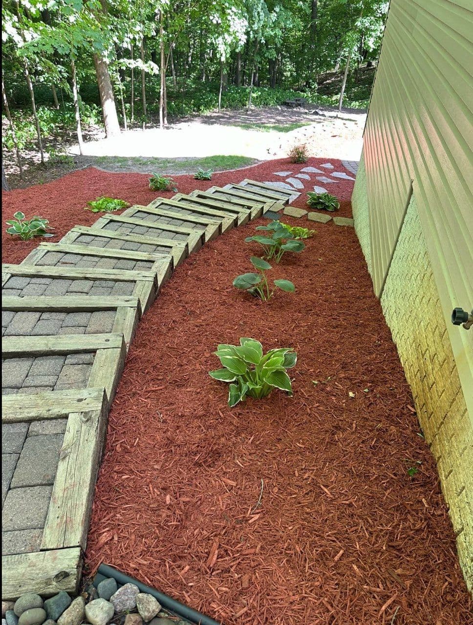 Project Springtime Landscaping with Red Mulch and Lush Foliage image